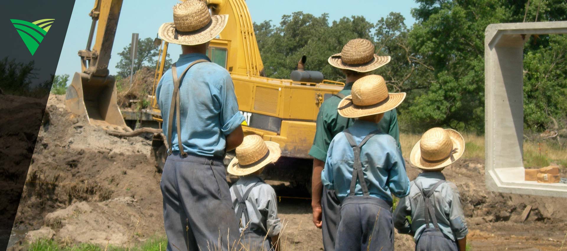 Amish children in front of CAT machinery